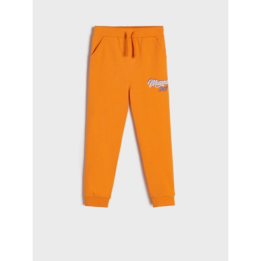 Sinsay - Spodnie dresowe z nadrukiem - Pomarańczowy Sinsay 128 Sinsay