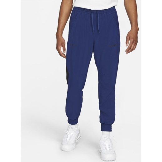 Męskie dresowe spodnie piłkarskie z tkaniny Nike F.C. - Niebieski Nike L Nike poland