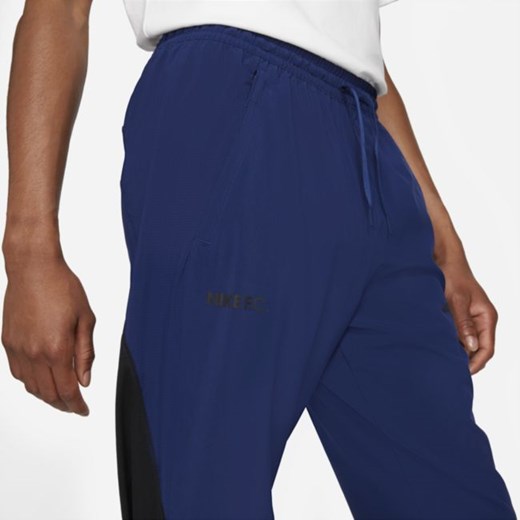 Męskie dresowe spodnie piłkarskie z tkaniny Nike F.C. - Niebieski Nike S Nike poland