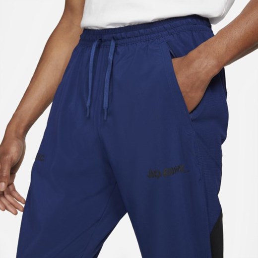 Męskie dresowe spodnie piłkarskie z tkaniny Nike F.C. - Niebieski Nike M Nike poland