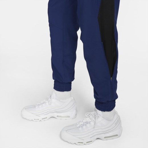 Męskie dresowe spodnie piłkarskie z tkaniny Nike F.C. - Niebieski Nike L Nike poland