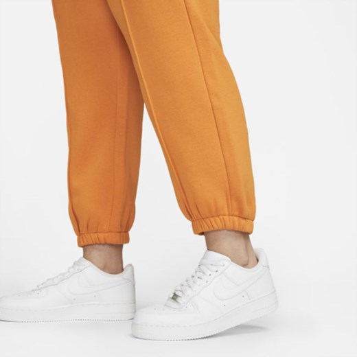 Spodnie damskie pomarańczowe Nike z dzianiny 