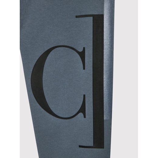 Calvin Klein Jeans Spodnie dresowe Mixed Monogram IB0IB01139 Szary Regular Fit 12Y promocja MODIVO