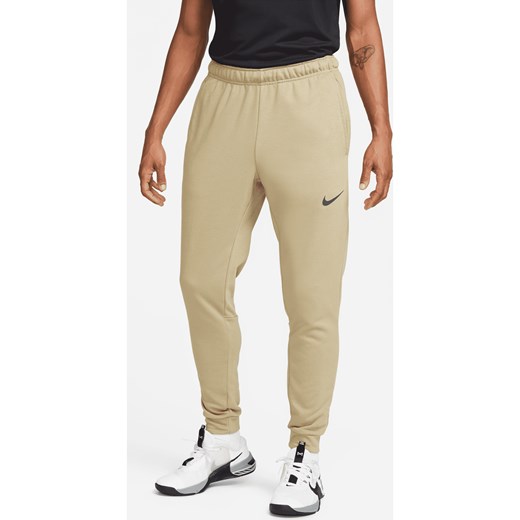 Męskie zwężane spodnie do fitnessu z dzianiny Dri-FIT Nike Dry - Brązowy ze sklepu Nike poland w kategorii Spodnie męskie - zdjęcie 161527242