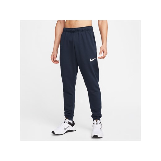 Męskie zwężane spodnie do fitnessu z dzianiny Dri-FIT Nike Dry - Niebieski ze sklepu Nike poland w kategorii Spodnie męskie - zdjęcie 161527874