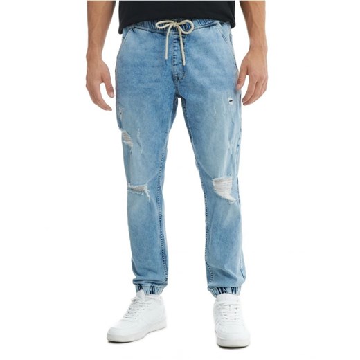 Cropp - Niebieskie jeansy jogger z przetarciami - niebieski Cropp 36/34 Cropp