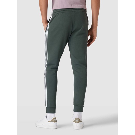 Spodnie dresowe z paskami z logo Adidas Sportswear M Peek&Cloppenburg 