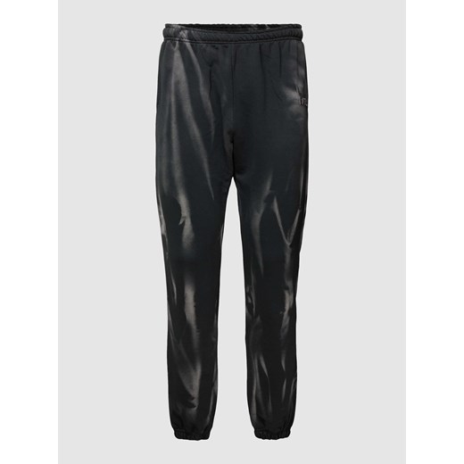 Spodnie dresowe z efektem batikowania model ‘Max Washed Loose Jogger’ ze sklepu Peek&Cloppenburg  w kategorii Spodnie męskie - zdjęcie 168110781