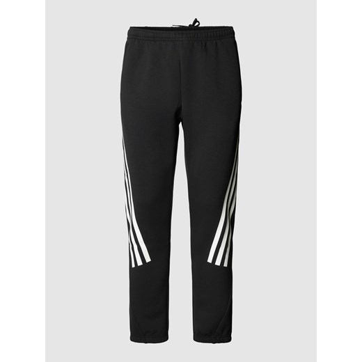 Spodnie sportowe z paskami w kontrastowym kolorze i elastycznym pasem ze sklepu Peek&Cloppenburg  w kategorii Spodnie męskie - zdjęcie 168324372