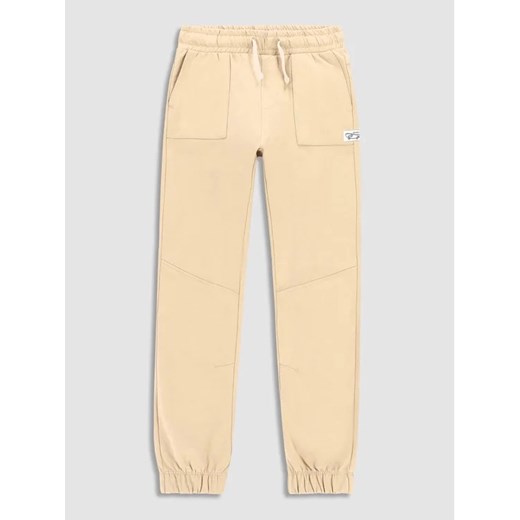 Coccodrillo Spodnie materiałowe WC3120103SKJ Beżowy Slim Fit ze sklepu MODIVO w kategorii Spodnie dziewczęce - zdjęcie 168406204