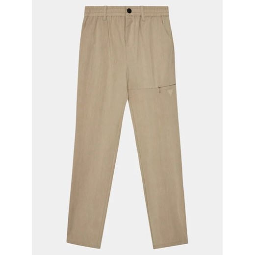 Guess Spodnie materiałowe Long L4RB00 WFKR0 Beżowy Regular Fit ze sklepu MODIVO w kategorii Spodnie chłopięce - zdjęcie 168430212
