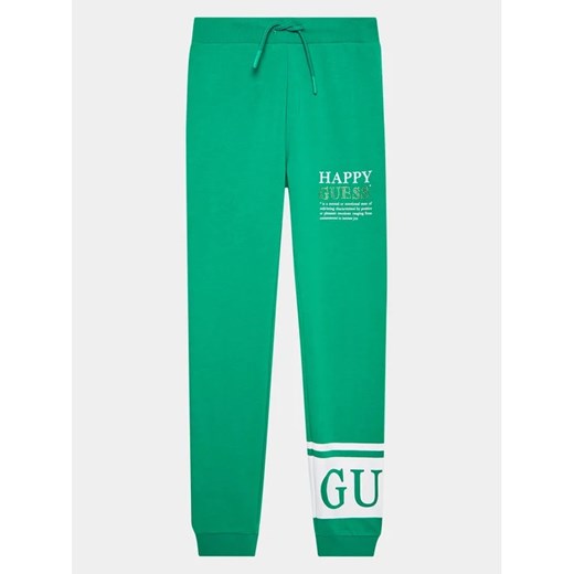 Guess Spodnie dresowe J3YQ11 KA6R4 Zielony Regular Fit ze sklepu MODIVO w kategorii Spodnie chłopięce - zdjęcie 168500950