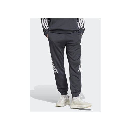 adidas Spodnie dresowe Future Icons Allover Print IB6127 Szary Regular Fit ze sklepu MODIVO w kategorii Spodnie męskie - zdjęcie 168583434