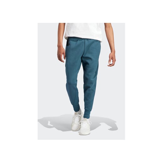 adidas Spodnie dresowe IN5100 Turkusowy Regular Fit ze sklepu MODIVO w kategorii Spodnie męskie - zdjęcie 168610782
