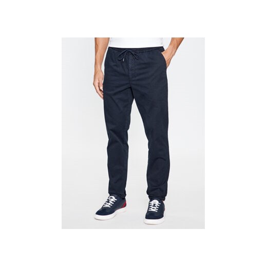 Tommy Hilfiger Spodnie materiałowe MW0MW32131 Granatowy Regular Fit ze sklepu MODIVO w kategorii Spodnie męskie - zdjęcie 168636203