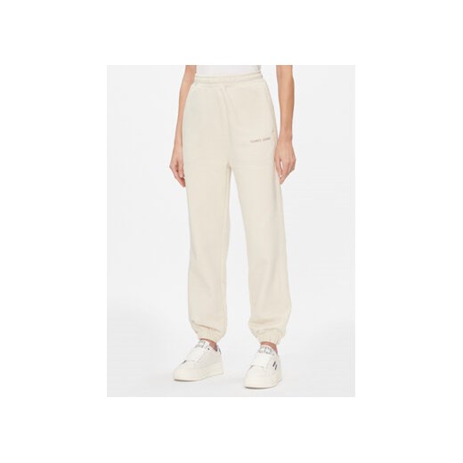 Tommy Jeans Spodnie dresowe Classics DW0DW17309 Beżowy Relaxed Fit ze sklepu MODIVO w kategorii Spodnie damskie - zdjęcie 168660171