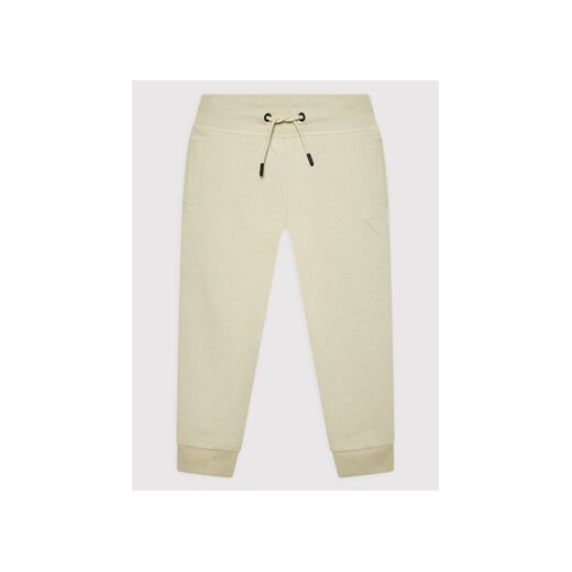 Guess Spodnie dresowe L2YQ46 KAIJ1 Beżowy Regular Fit ze sklepu MODIVO w kategorii Spodnie chłopięce - zdjęcie 168673052
