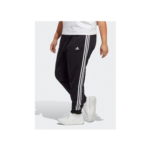 adidas Spodnie dresowe Essentials 3-Stripes French Terry Cuffed Joggers (Plus Size) IB8745 Czarny Slim Fit ze sklepu MODIVO w kategorii Spodnie damskie - zdjęcie 169340094