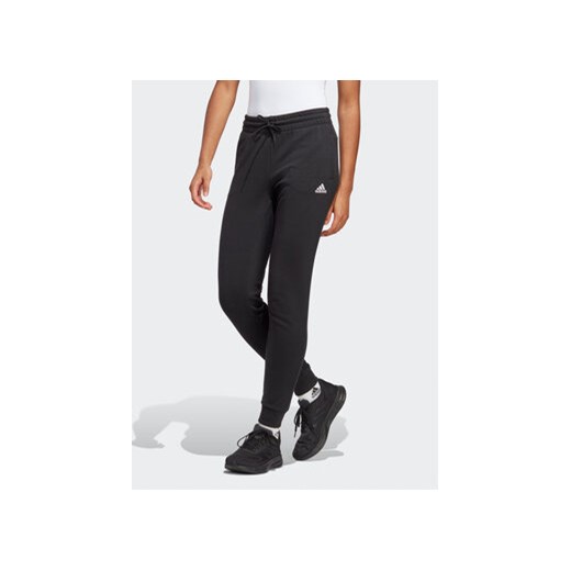 adidas Spodnie dresowe Essentials Linear French Terry Cuffed Joggers IC6868 Czarny Slim Fit ze sklepu MODIVO w kategorii Spodnie damskie - zdjęcie 169340993
