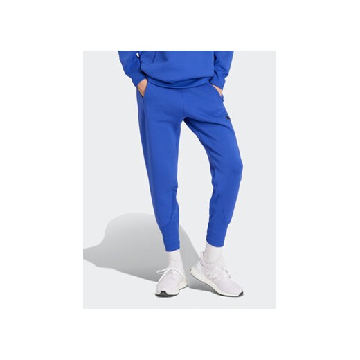adidas Spodnie dresowe Z.N.E. IS3914 Niebieski Regular Fit ze sklepu MODIVO w kategorii Spodnie damskie - zdjęcie 169423262