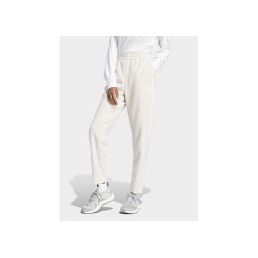 adidas Spodnie dresowe Train Essentials IS3969 Różowy Loose Fit ze sklepu MODIVO w kategorii Spodnie damskie - zdjęcie 169491723