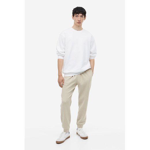 H & M - Spodnie dresowe Regular Fit - Brązowy ze sklepu H&M w kategorii Spodnie męskie - zdjęcie 169676733