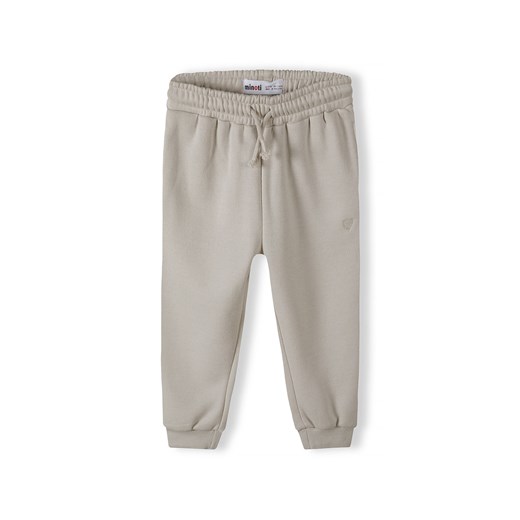 Beżowe spodnie dresowe Minoti ze sklepu 5.10.15 w kategorii Spodnie chłopięce - zdjęcie 169690403