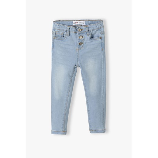 Jasnoniebieskie spodnie jeansowe skinny dla małej dziewczynki ze sklepu 5.10.15 w kategorii Spodnie dziewczęce - zdjęcie 169715804