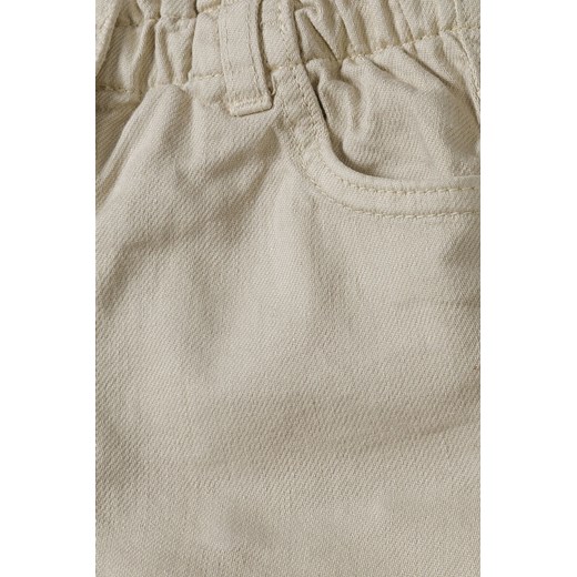 Beżowe krótkie spodenki tkaninowe dla niemowlaka Minoti 80/86 5.10.15