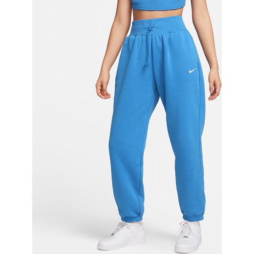 Damskie spodnie dresowe o kroju oversize z wysokim stanem Nike Sportswear Phoenix Fleece - Niebieski ze sklepu Nike poland w kategorii Spodnie damskie - zdjęcie 169754874