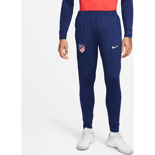 Męskie dzianinowe spodnie piłkarskie Atlético Madryt Strike Nike Dri-FIT - Niebieski ze sklepu Nike poland w kategorii Spodnie męskie - zdjęcie 169756623