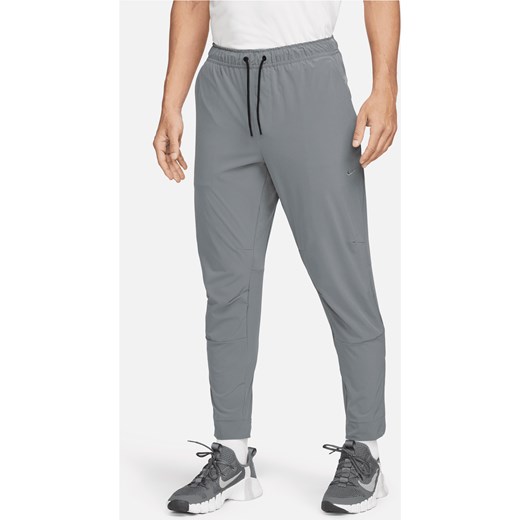 Męskie uniwersalne spodnie ze ściągaczami i zamkami Dri-FIT Nike Unlimited - Szary ze sklepu Nike poland w kategorii Spodnie męskie - zdjęcie 169757342