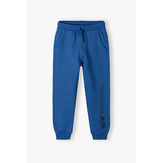 Niebieskie spodnie dresowe dla chłopca - New Generation ze sklepu 5.10.15 w kategorii Spodnie chłopięce - zdjęcie 169782560