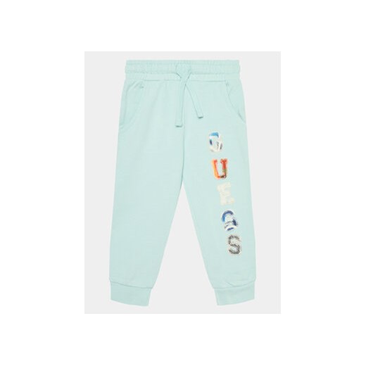 Guess Spodnie dresowe N4GQ11 KA6R3 Niebieski Regular Fit ze sklepu MODIVO w kategorii Spodnie chłopięce - zdjęcie 170236982