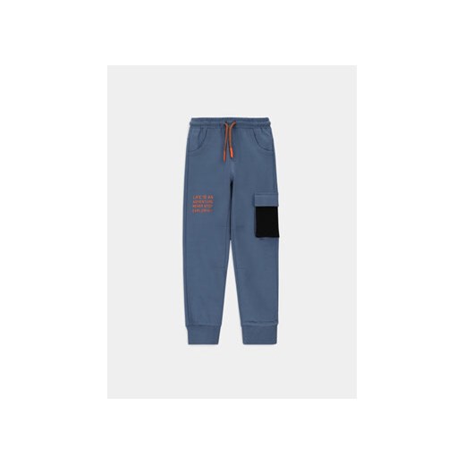 Coccodrillo Spodnie dresowe WC4120102DEK Niebieski Slim Fit ze sklepu MODIVO w kategorii Spodnie chłopięce - zdjęcie 170237214