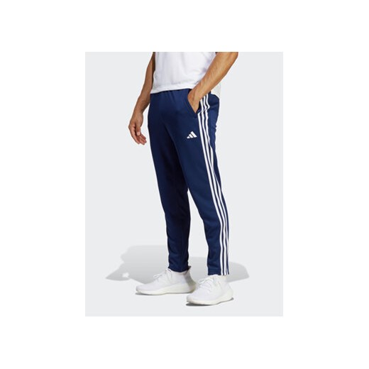 adidas Spodnie dresowe Train Essentials 3-Stripes Training IB8169 Niebieski Regular Fit ze sklepu MODIVO w kategorii Spodnie męskie - zdjęcie 170659372