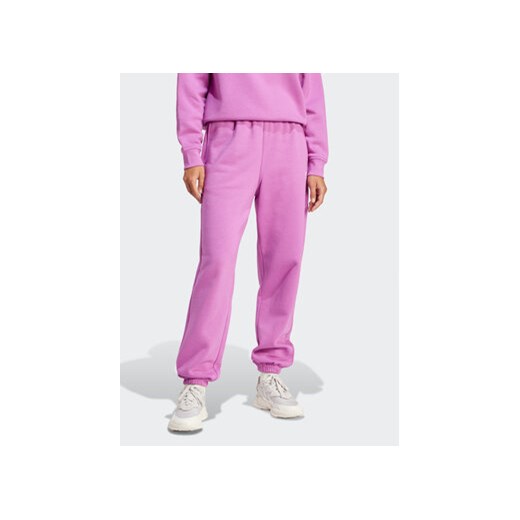 adidas Spodnie dresowe Essentials IR5964 Różowy Regular Fit ze sklepu MODIVO w kategorii Spodnie damskie - zdjęcie 170887724