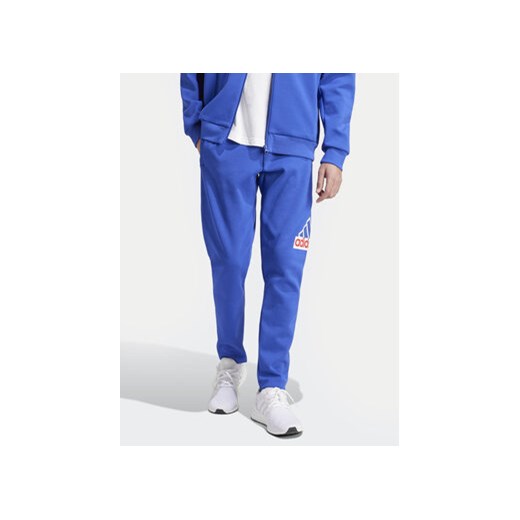 adidas Spodnie dresowe Future Icons Badge of Sport IS9594 Niebieski Regular Fit ze sklepu MODIVO w kategorii Spodnie męskie - zdjęcie 170942444
