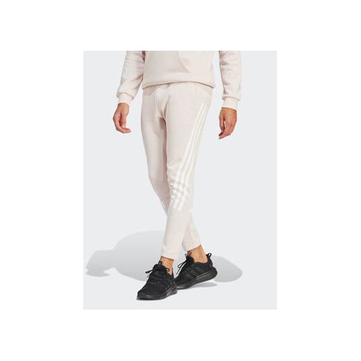 adidas Spodnie dresowe Future Icons 3-Stripes IR9155 Różowy Slim Fit ze sklepu MODIVO w kategorii Spodnie męskie - zdjęcie 171342351