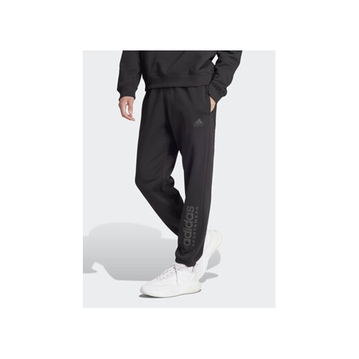 adidas Spodnie dresowe ALL SZN Fleece Graphic IW1201 Czarny Regular Fit ze sklepu MODIVO w kategorii Spodnie męskie - zdjęcie 171343920