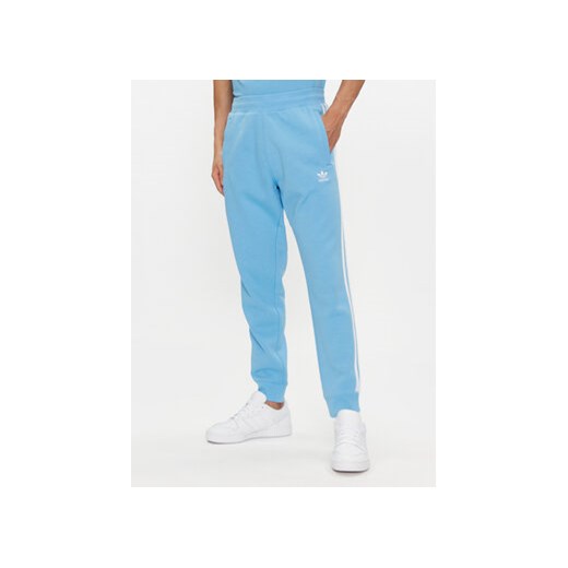 adidas Spodnie dresowe adicolor 3-Stripes IM9451 Niebieski Slim Fit ze sklepu MODIVO w kategorii Spodnie męskie - zdjęcie 171953691