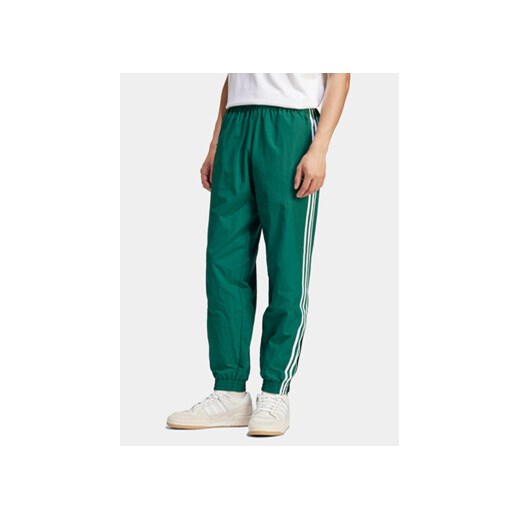 adidas Spodnie dresowe Adicolor Woven Firebird IT2497 Zielony Regular Fit ze sklepu MODIVO w kategorii Spodnie męskie - zdjęcie 172104854
