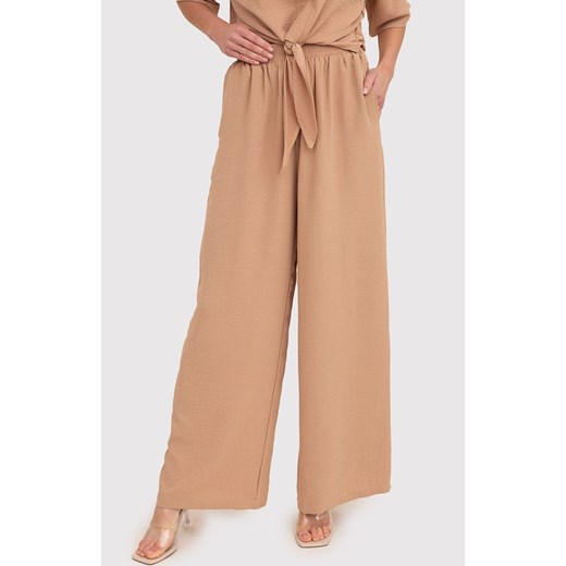 Beżowe spodnie z szerokimi nogawkami i elastyczną talią TRA038, Kolor beżowy, Rozmiar L, AX Paris ze sklepu Primodo w kategorii Spodnie damskie - zdjęcie 172548773