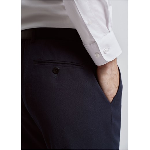 Granatowe spodnie garniturowe męskie Ochnik One Size wyprzedaż OCHNIK