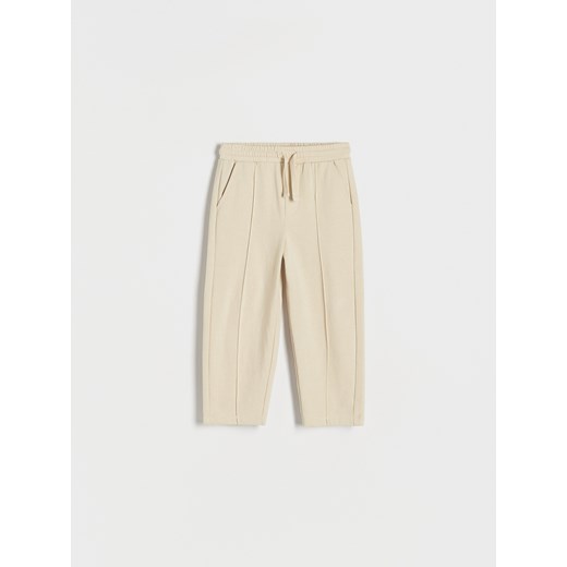Reserved - Dresowe spodnie z przeszyciami - kremowy ze sklepu Reserved w kategorii Spodnie i półśpiochy - zdjęcie 173154300