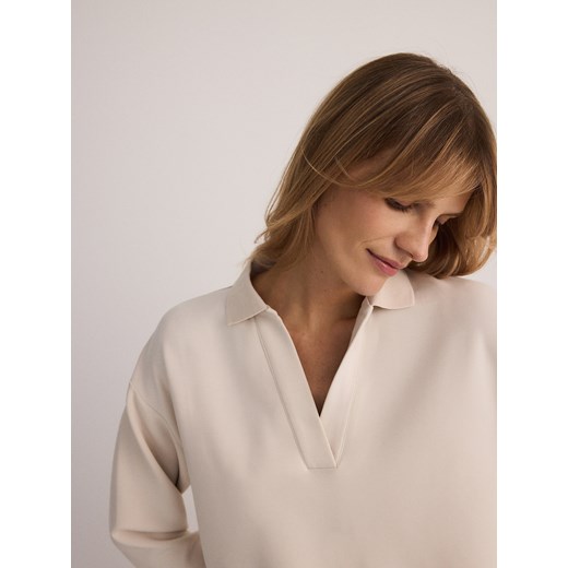 Bluzka damska Reserved z kołnierzykiem biała z długim rękawem 