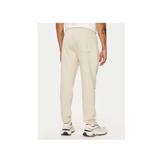 Tommy Jeans Spodnie dresowe Flag DM0DM20473 Beżowy Slim Fit Tommy Jeans XXL MODIVO