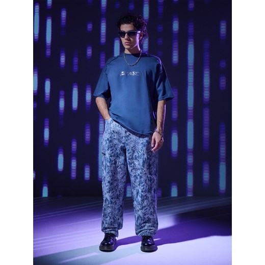 Cropp - Spodnie loose ze wzorem camo - surowy granatowy ze sklepu Cropp w kategorii Spodnie męskie - zdjęcie 177701652