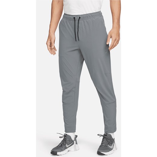 Męskie uniwersalne spodnie ze ściągaczami i zamkami Dri-FIT Nike Unlimited - Szary ze sklepu Nike poland w kategorii Spodnie męskie - zdjęcie 178606923