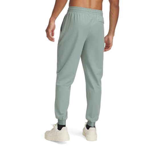 Męskie spodnie treningowe Under Armour UA Unstoppable Joggers - zielone ze sklepu Sportstylestory.com w kategorii Spodnie męskie - zdjęcie 179003132